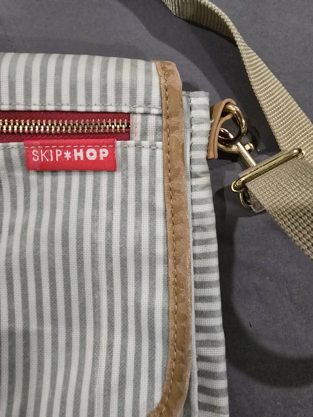 Skip Hop Gray and White Striped Messenger Bag with Tan Trim and Red Accent